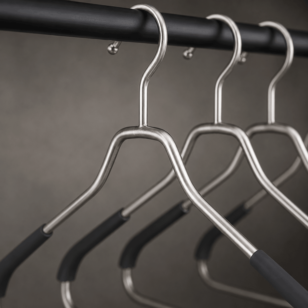 Close-up of brushed stainless steel hanger construction highlighting durability and finish