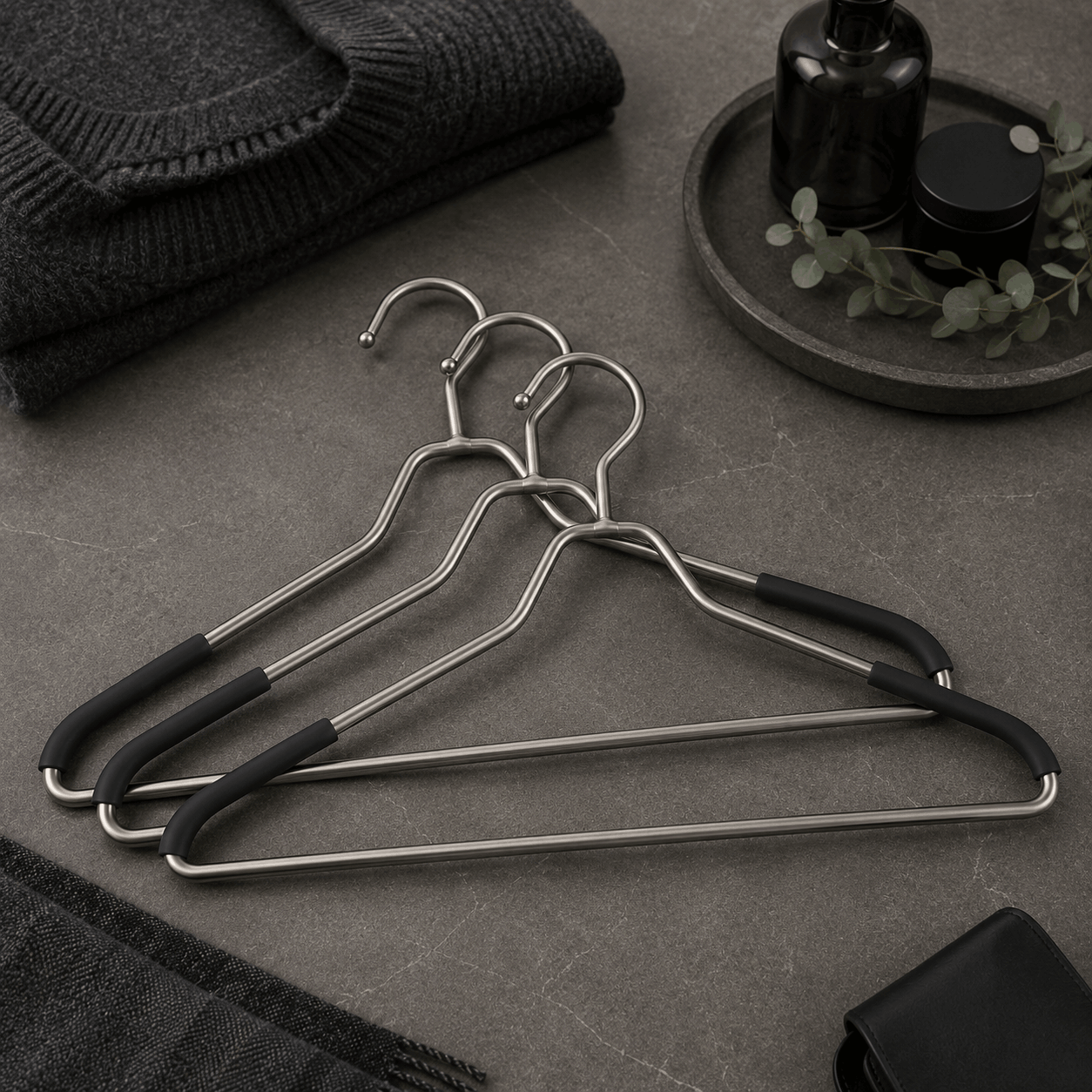Stainless steel clothes hangers displayed in a premium wardrobe-inspired environment