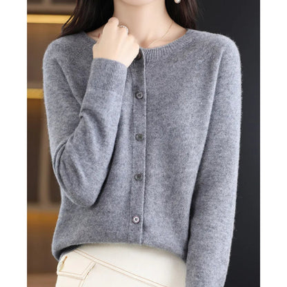 Front view of a woman wearing a grey fine knit button-front cardigan, with all buttons fastened.