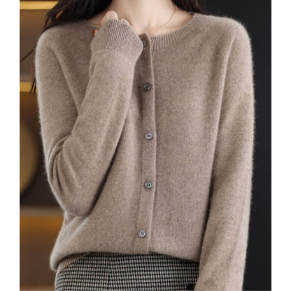 A model wears a light brown button-up cardigan.
