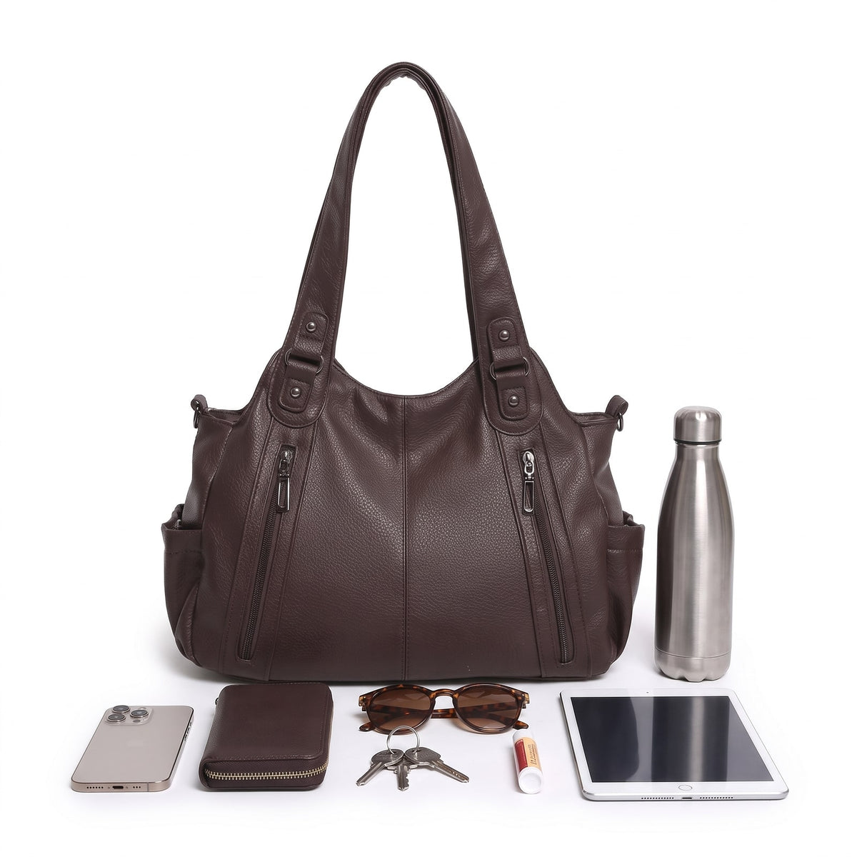 Front view of the dark brown faux leather hobo bag surrounded by everyday items like a phone, wallet, keys, sunglasses, lip balm, tablet, and water bottle, on a white background.