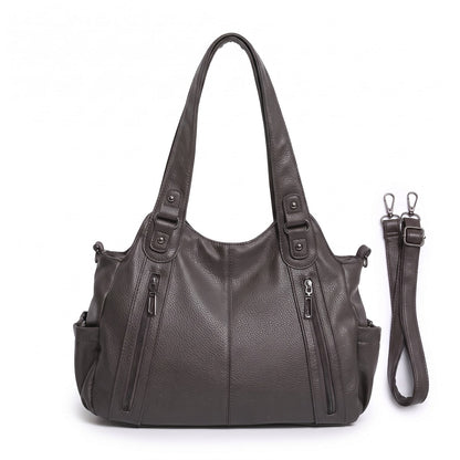 Front view of a grey faux leather shoulder bag with an adjustable strap.