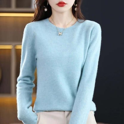 Front view of a woman wearing a light blue fine-knit crew neck sweater.