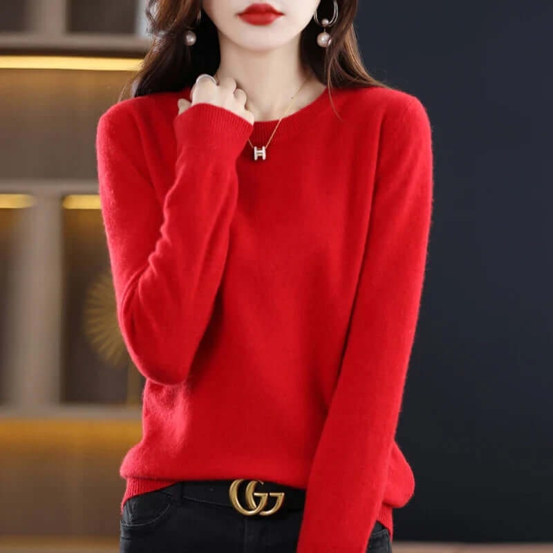 A model wears a red long-sleeved crew neck sweater, styled with a gold 'H' pendant necklace and a 'G' logo belt.