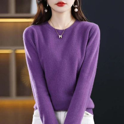 A model wears a purple long-sleeved crew neck sweater, accessorized with a gold 'H' pendant necklace.