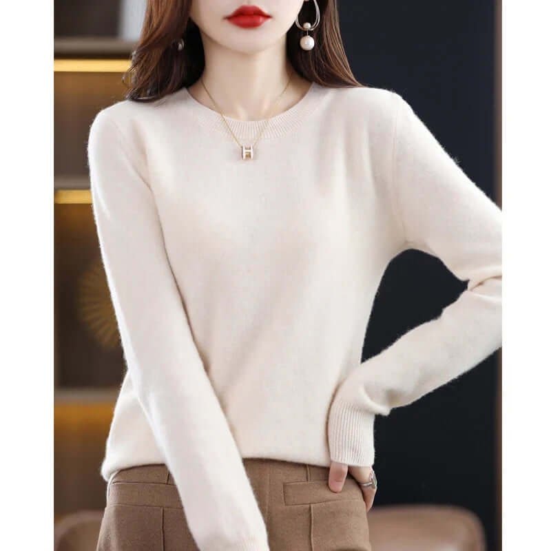 A model wearing an off-white long-sleeved crew neck sweater.
