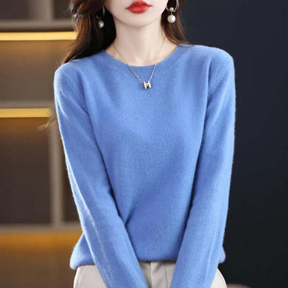 A model wearing a blue long-sleeved crew neck sweater.
