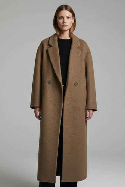 Front view of a woman wearing the brown double-breasted longline coat open over a black top.