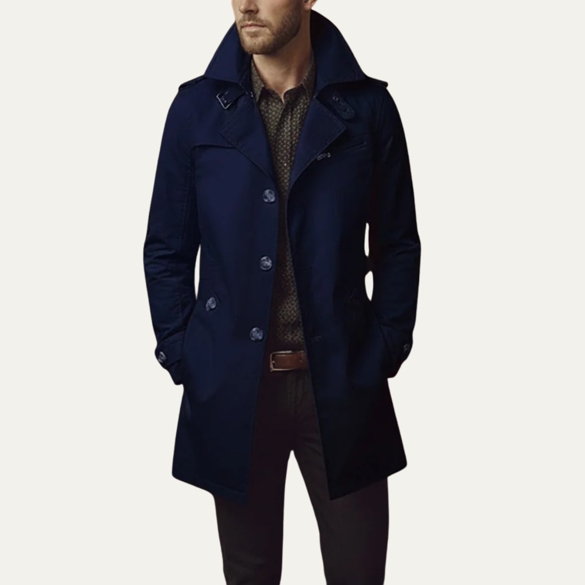 Front view of a man wearing a navy blue single-breasted trench coat with a patterned shirt and dark trousers.