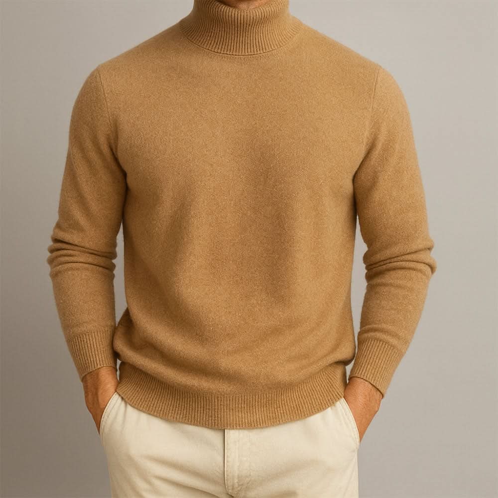 Front view of a man wearing a camel-colored cashmere turtleneck sweater with hands in pockets.